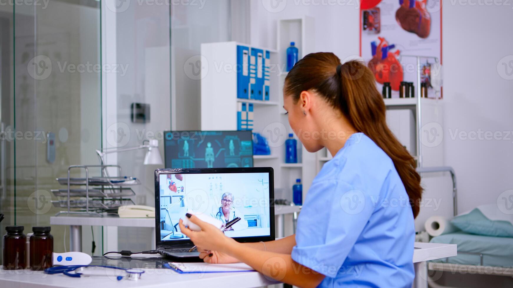 Medical student talking during health conference with senior doctor, listening advices and taking notes. Remote healthcare service, virtual meeting, telemedicine, online call webinar. photo