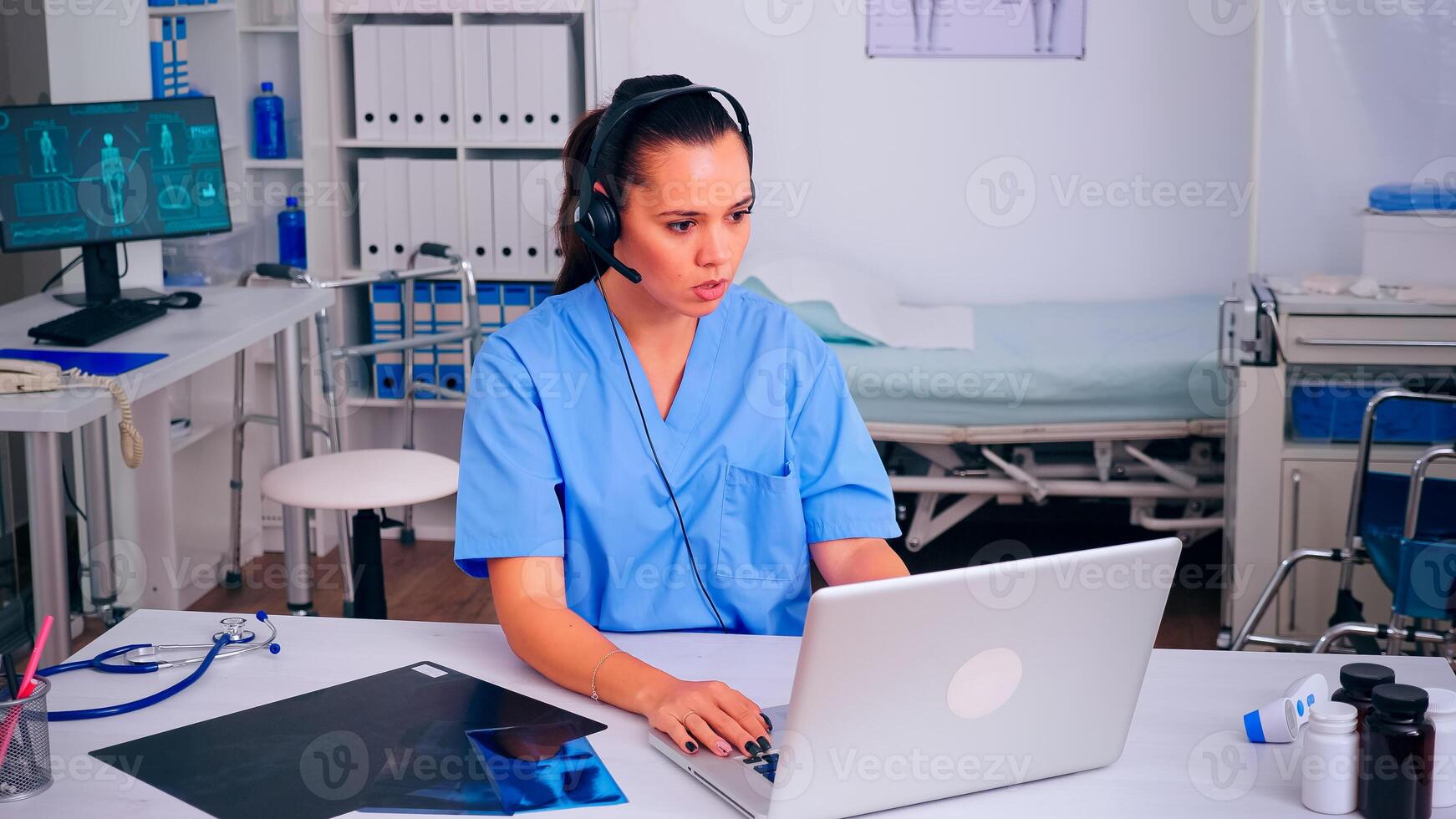 Healthcare physician prescribing prescriptions for patients during telehealth using headset, answering calls. Specialist health practitioner in medicine uniform, doctor nurse helping with appointment photo