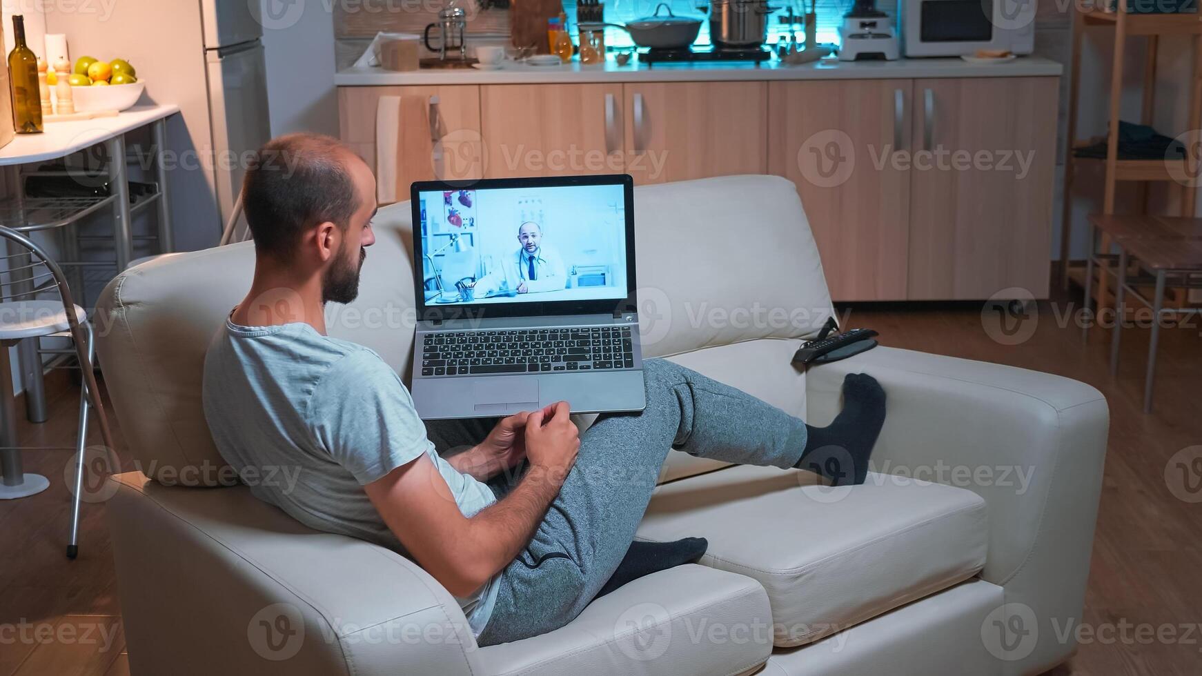 Unhealty man talking with physician doctor about covid-19 treatment during online videocall appointment. Caucasian male sitting in front of laptop computer disscusing about virus symptoms photo