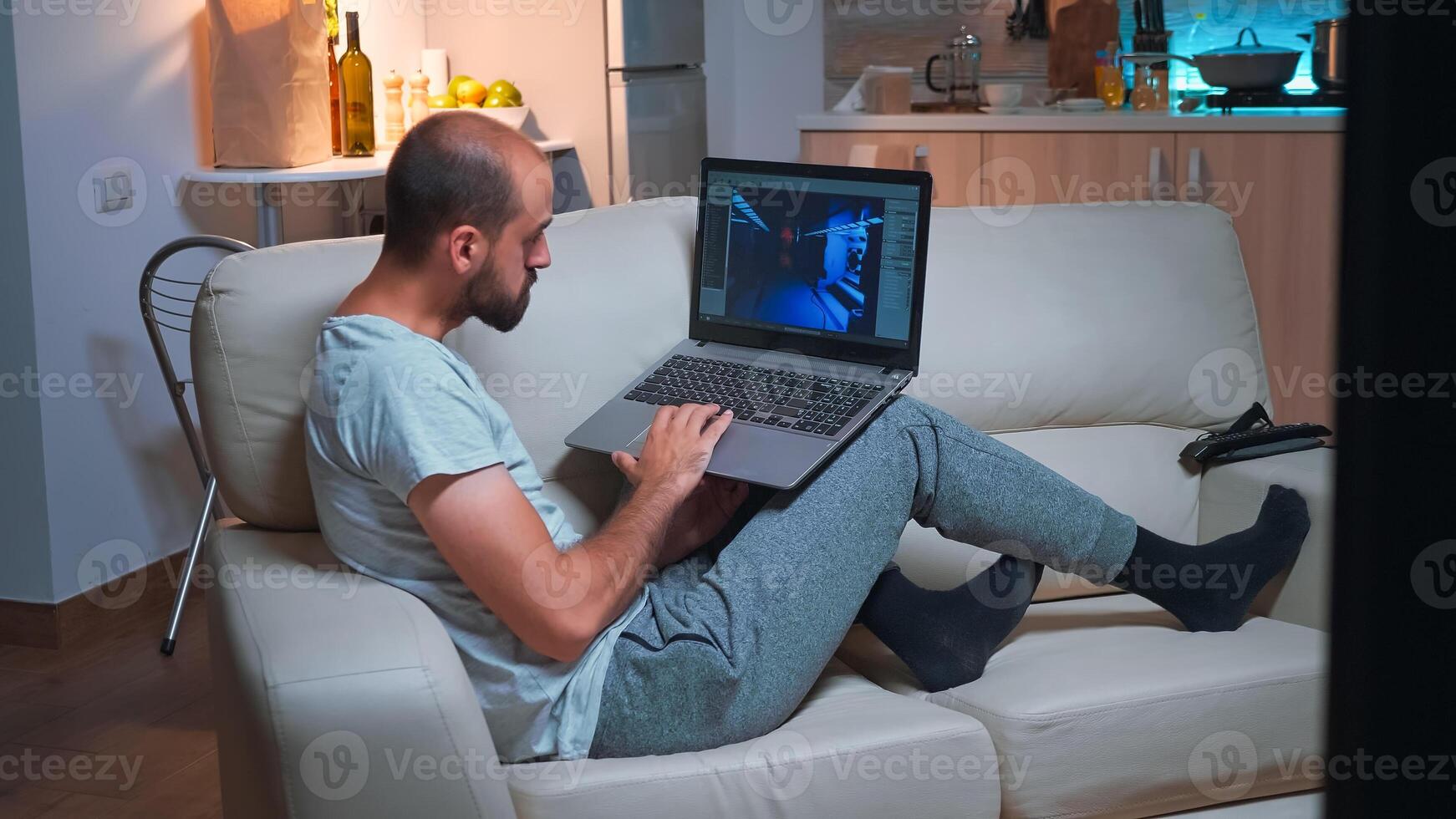Professional game developer working on gameplay and game level late at night from the confort of his home. Professional creative man in the evening developing startup technology photo