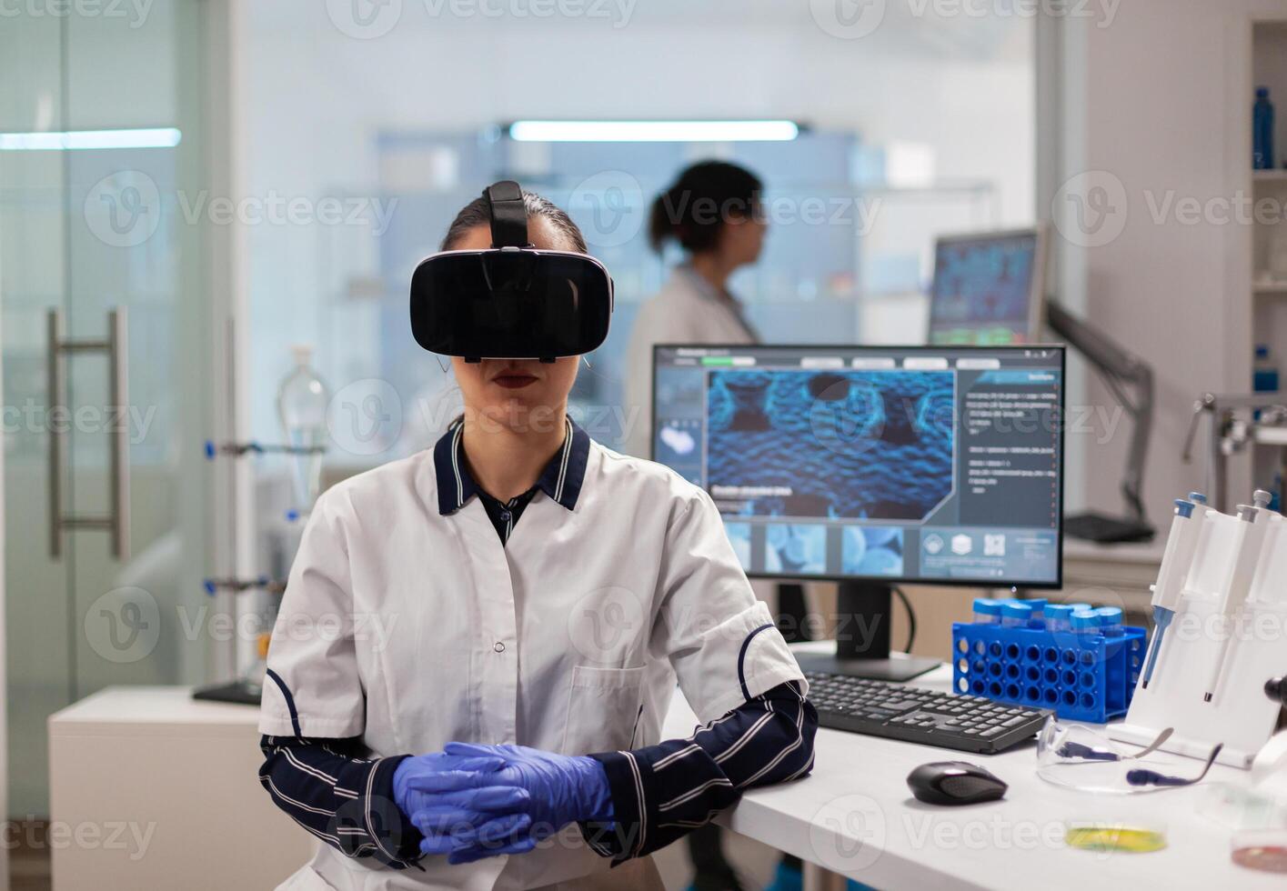 Professional scientist wearing virtual reality glasses using medical inovation in lab. Team of researchers working with equipment device, future, medicine, healthcare, professional, vision, simulator. photo
