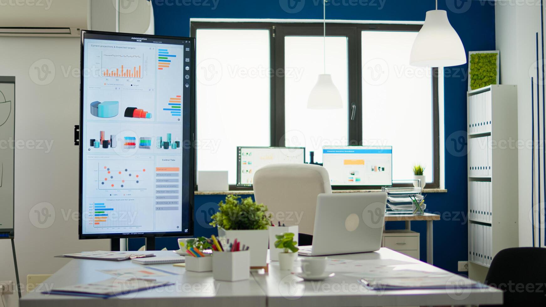 Bright business office desk ready for morning meeting with financial charts on screens, in empty conference room. Brainstorming area with nobody in it, strategy and statistics zone in start up company photo