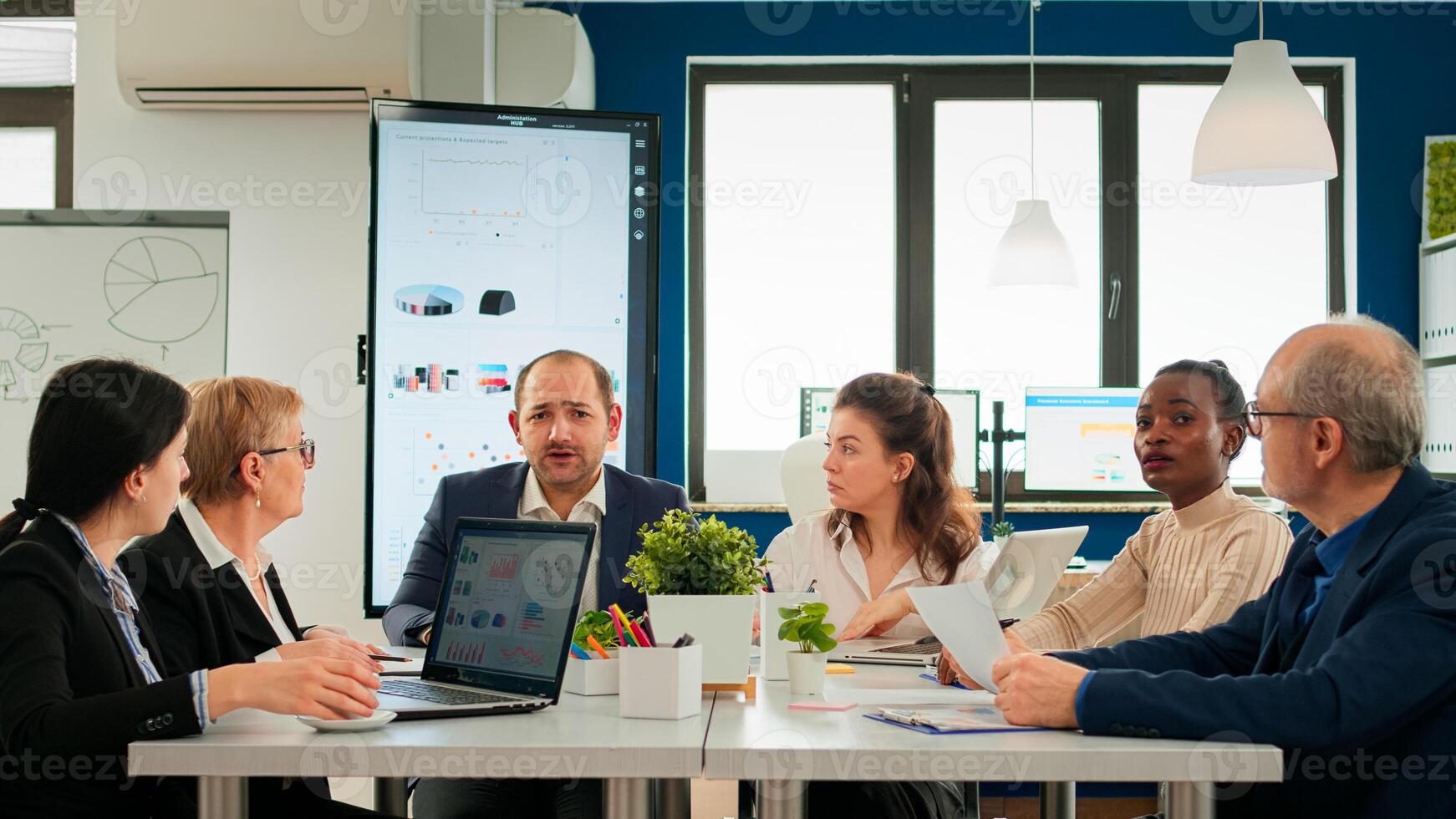 Multiethnical team talking with remote manager using call during virtual meeting sitting in startup financial business. Internet conference call technology talk with investors, corporate brainstorming via web photo