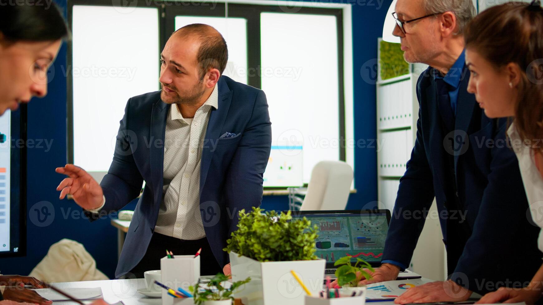 Team of diverse startup company colleague entrepreneur meeting in professional workplace broadroom, brifing and sharing ideas over financial strategy management. Multiracial business people planning. photo