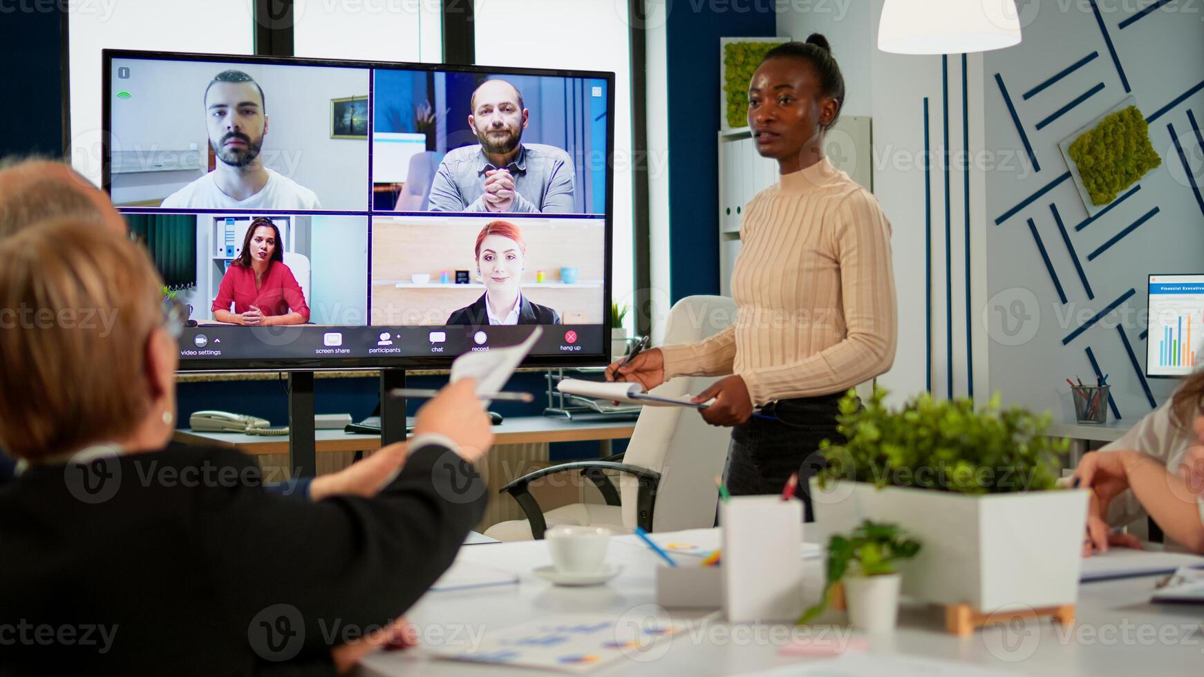 African woman discussing with remote managers on call presenting new partners on webcam. Confident businesspeople talking to web cam streaming webcast training, doing online conference call. photo