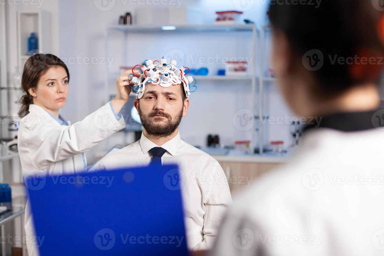 Neuroscience doctor showing on clipboard treatment against brain disease explaning to patient diagnosis of illness. Woman sitting in neurological scientific lab treating nervous system dysfunctions photo
