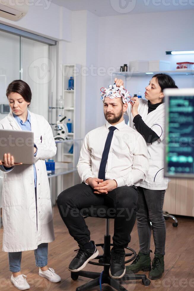 Women team neurological researchers working together developing treatment for diagnosis of brain disease, explaning eeg results, health status, brain functions, nervous system and tomography scan photo