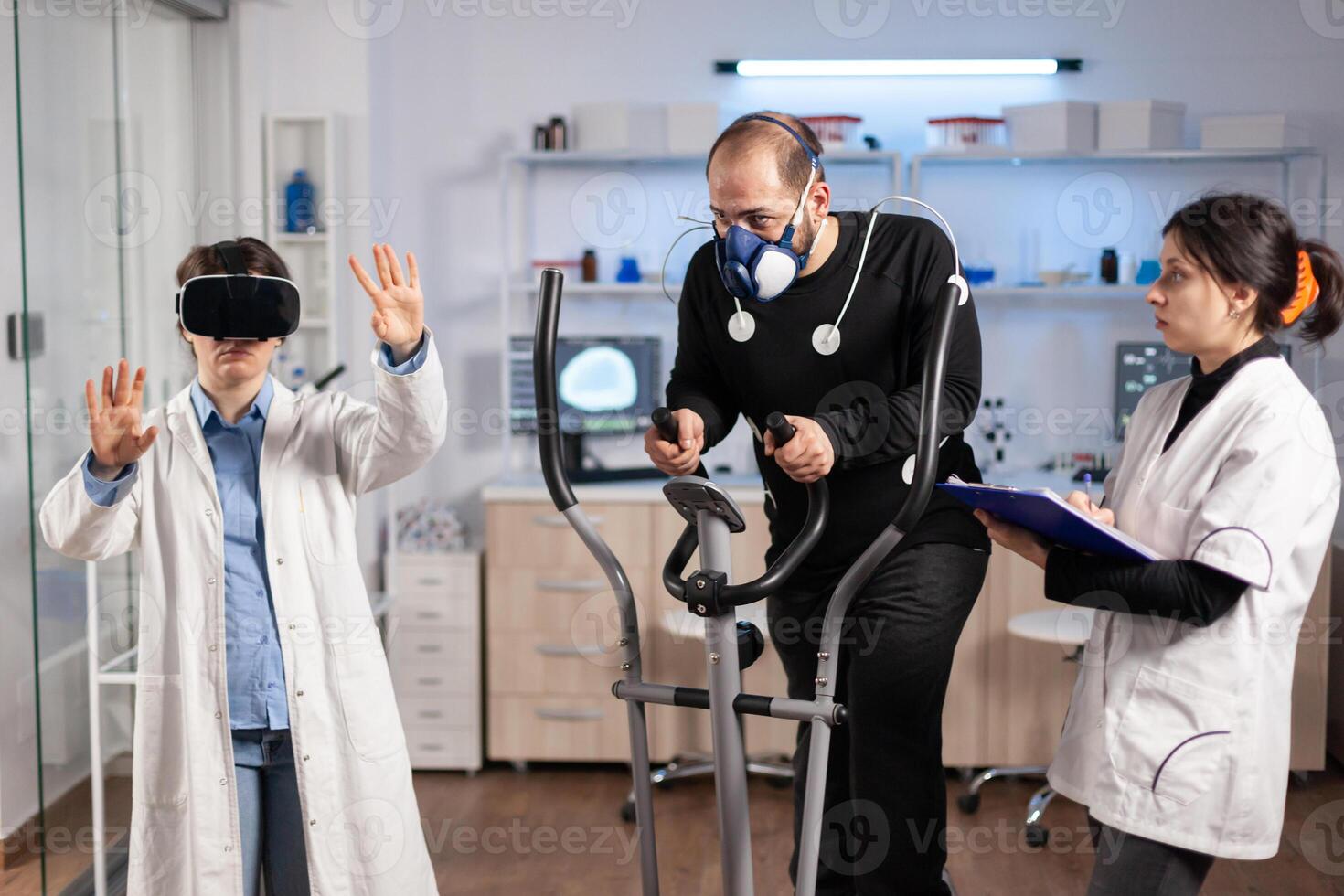 Team of scientist using virtual reality technology, in sports lab science. Professional young athlete sports endurance, cross training test with mask exercise. photo