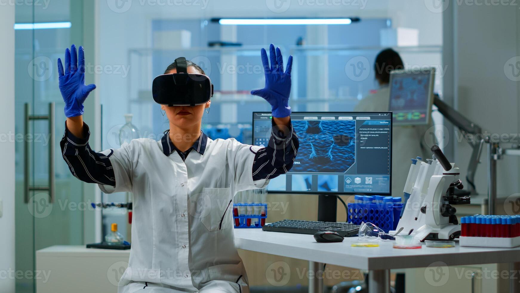 Professional scientist wearing virtual reality glasses using medical inovation in lab. Team of researchers working with equipment device, future, medicine, healthcare, professional, vision, simulator photo