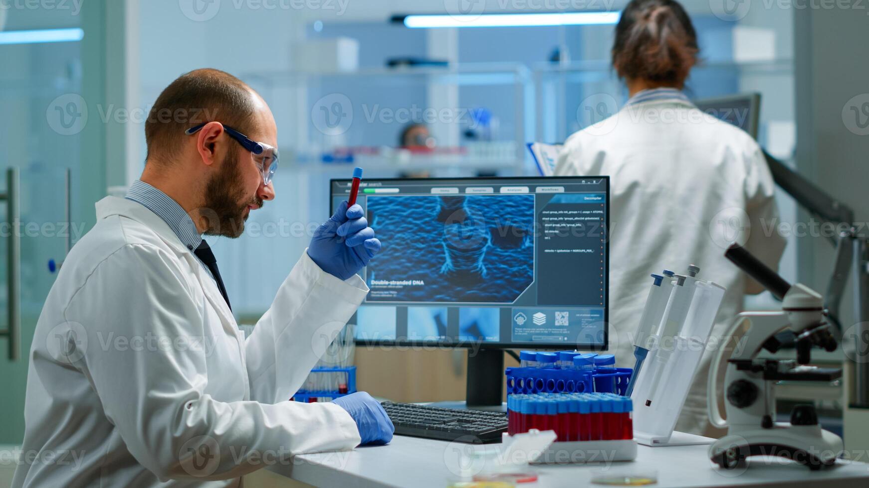 Male researcher working in laboratory research and experiment corona disease sample case for medical health technology against covid-19 virus. Viorolog in professional lab analysing vaccine evolution photo