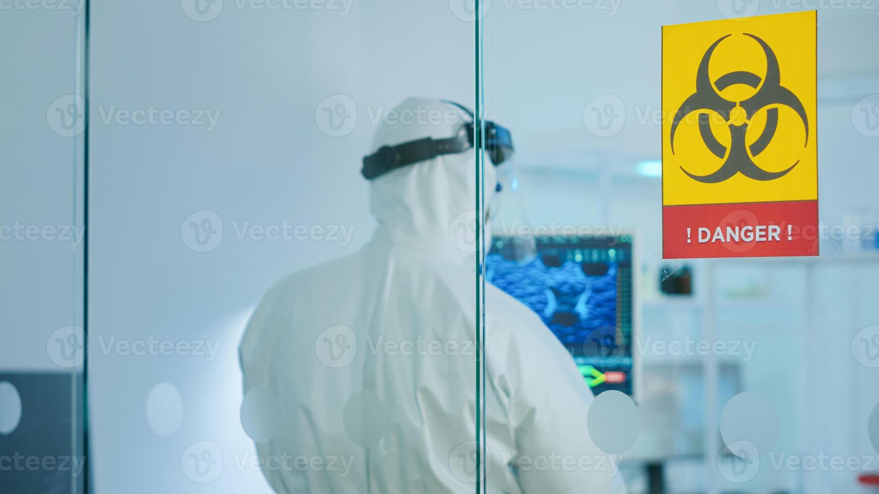 Team of chemist doctors wearing protection suit working in danger area of medical research laboratory. Scientist examining vaccine evolution using high tech for research in treatment for covid19 virus photo