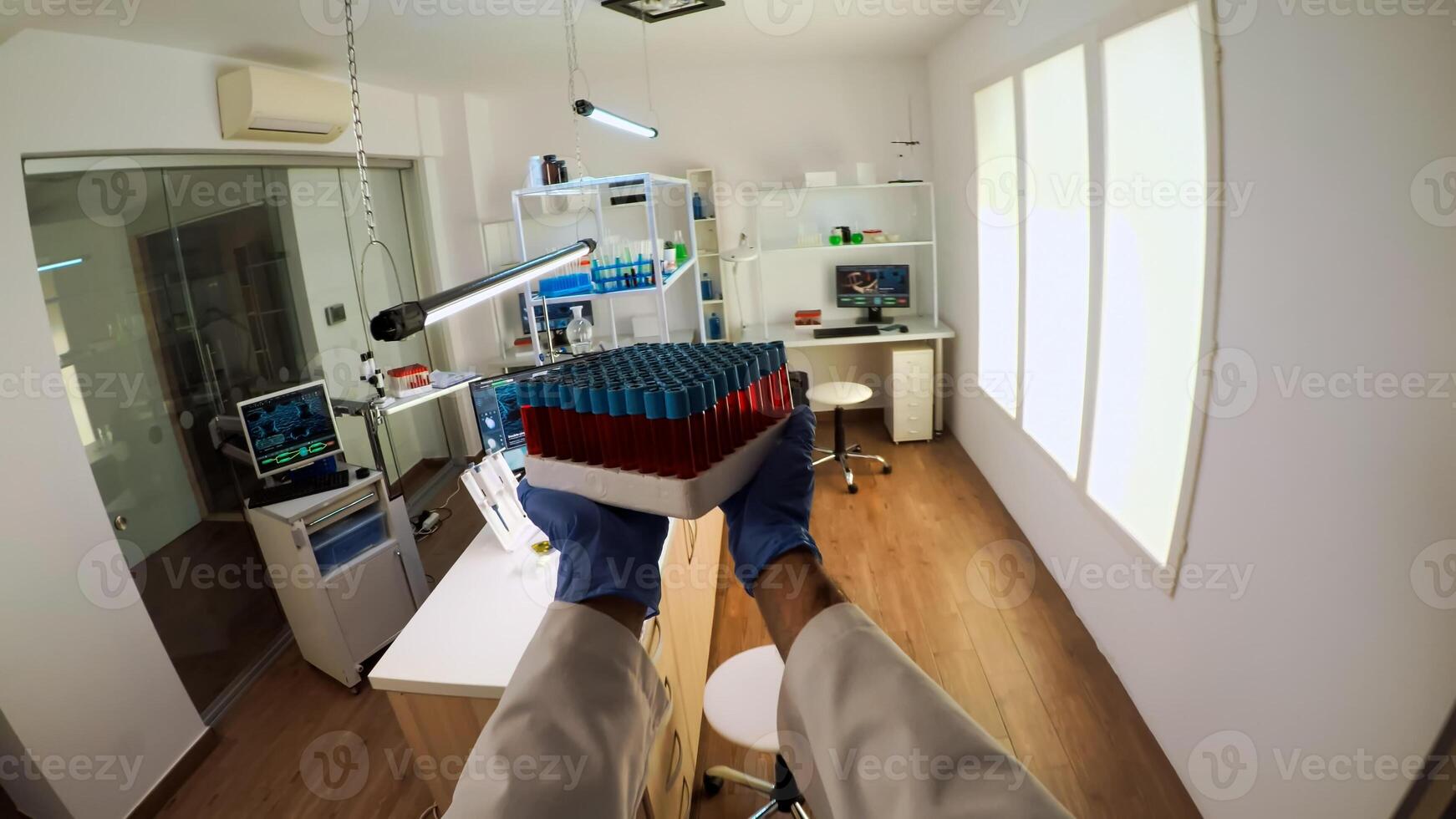 POV of chemist doctor working on pc examining vaccine development in scientific modern equipped laboratory. Scientist stuff using high tech and technology researching treatment against covid19 virus photo