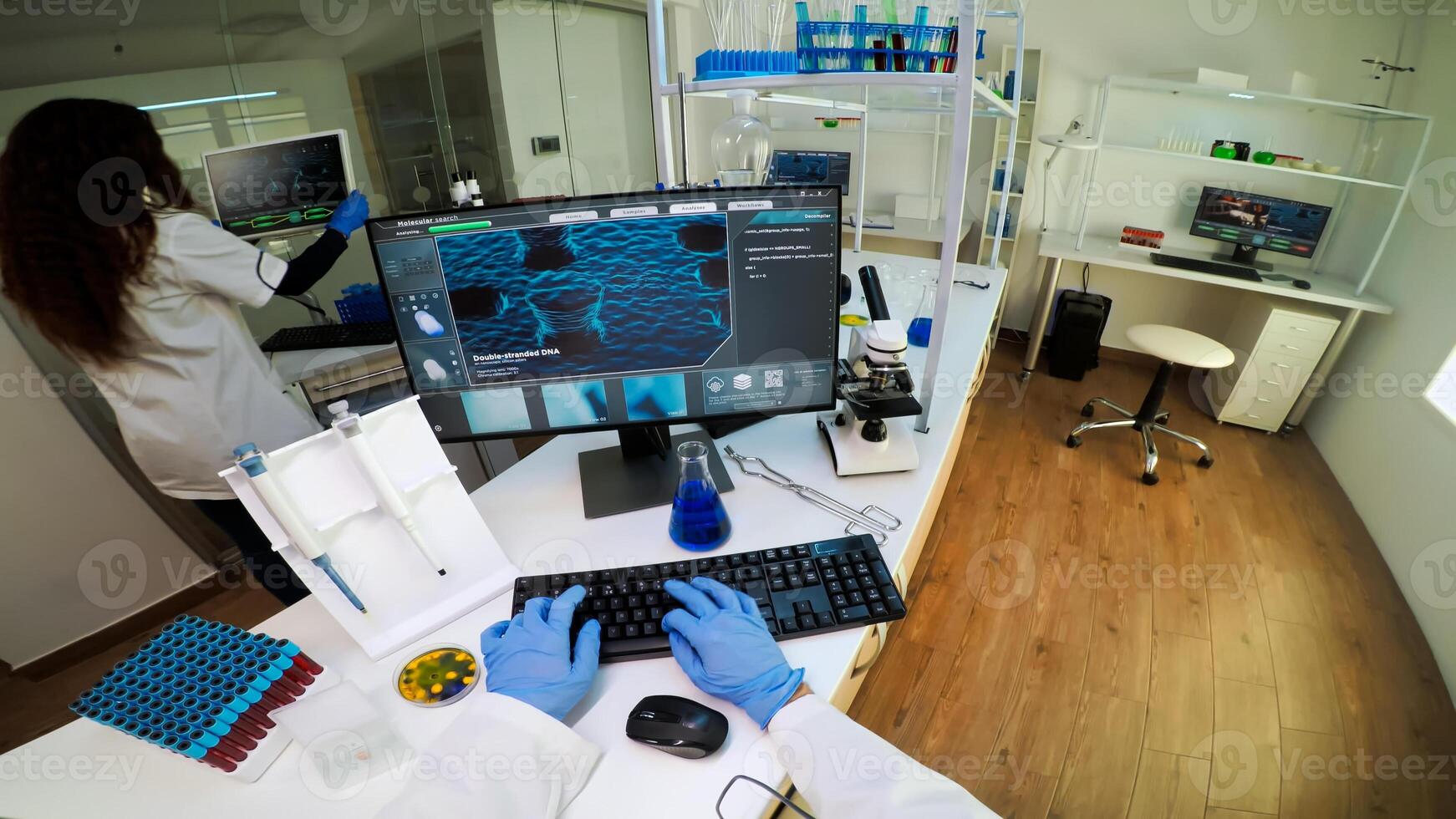 POV of technologist doing laboratory test examining sample, chemist holding tube with liquids inside. Scientist working with various bacteria tissue and DNA scan image, examining vaccine evolution photo
