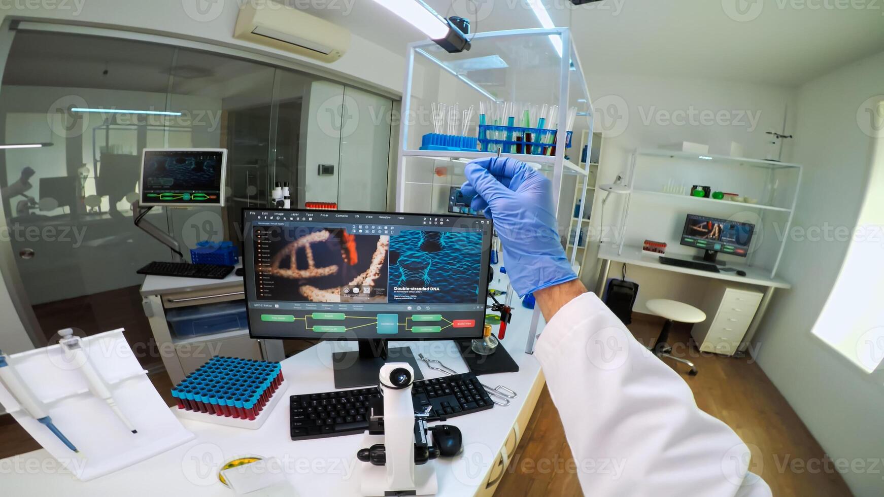 POV of scientist looking at biological samples under microscope typing on pc. Team of chemists working in lab, examining virus evolution using high tech for scientific research of vaccine development. photo