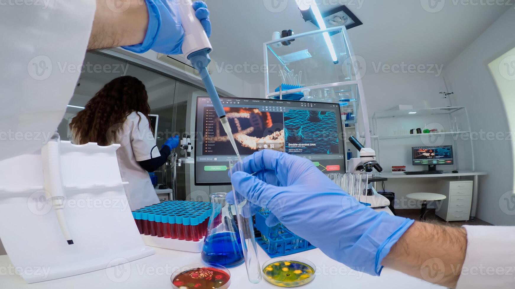FPV of scientist using micropipette for filling test tube with liquid, conducting chemical experiment working in pharmaceutical lab with medicine, biotechnology researchers, developing vaccine photo