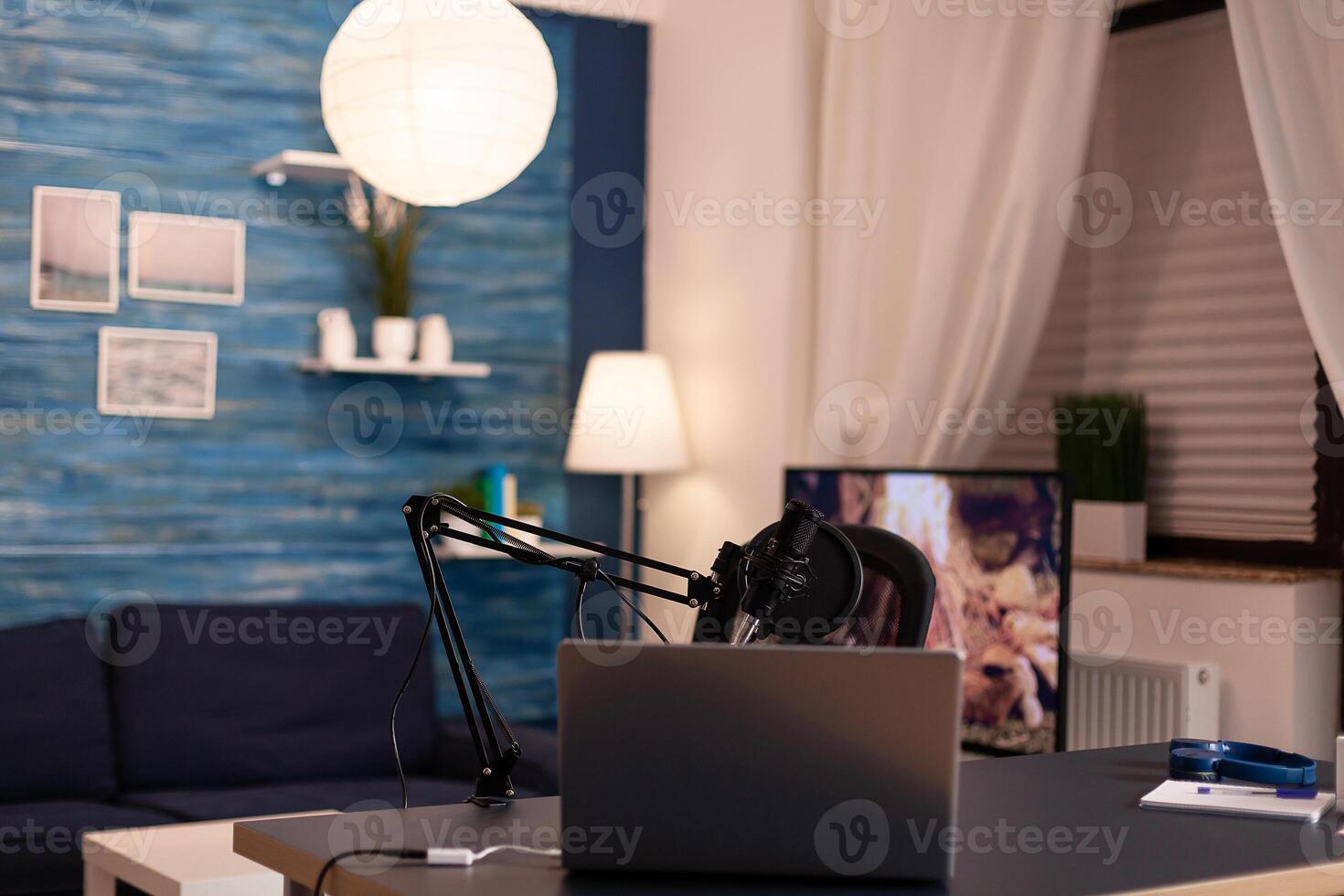 Podcast home studio in living room with professional brodcasting gear with nobody in it. Influencer recording social media content with production microphone, digital web internet streaming station. photo