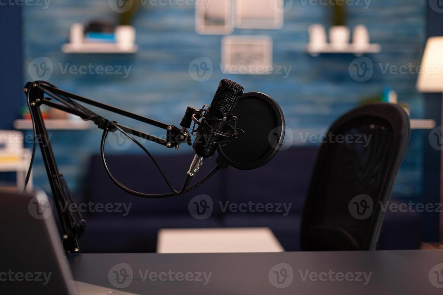 Empty podcast room with professional microphone in vlogger home studio in living. Influencer recording social media content with production microphone, digital web internet streaming station. photo