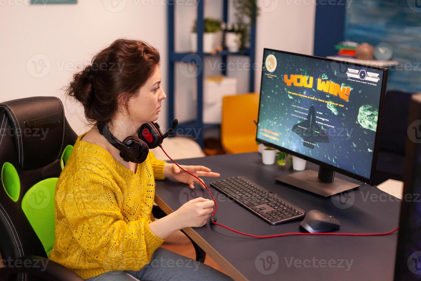 Excited player winning an important virtual egame competition of space shooter game playing on powerful computer. Pro gamer streaming cyber performing gaming tournament in cyberspace. photo