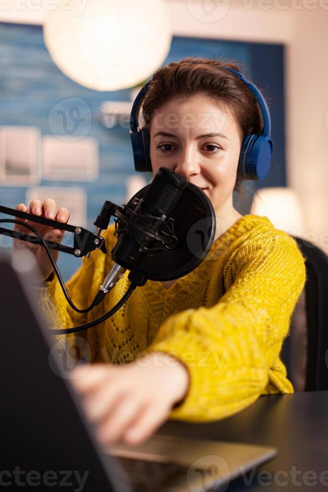 Blogger speaking with followers on live podcast using headphones. Creative online show On-air production internet broadcast host streaming live content, recording digital social media communication. photo