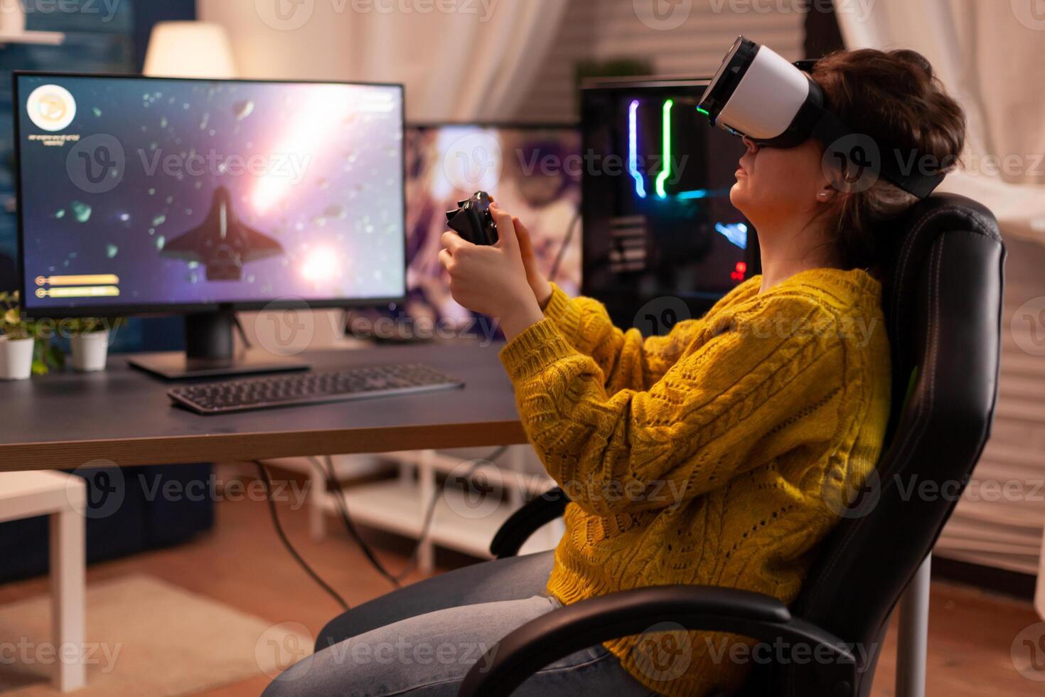 Professional gamer wearing virtual reality headset using wireless controller. Pro esport team player streamer playing gaming tournament on powerful RGB computer, using modern streaming technology. photo