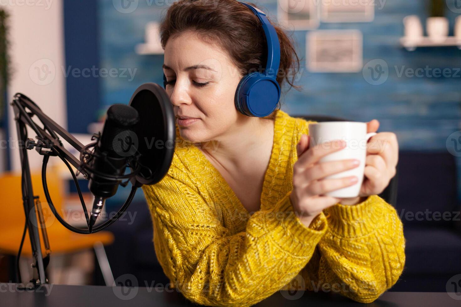 Woman vlogger recording to camera tutorial about lifestyle in home podcast studio during livestreaming. On-air online production internet broadcast show host streaming live content for social media. photo