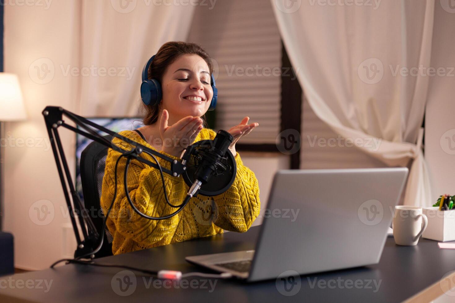 Vlogger speaking with follower on live using professional microphone wearing headphones. Creative online show On-air production internet broadcast host streaming live content, recording digital social. photo