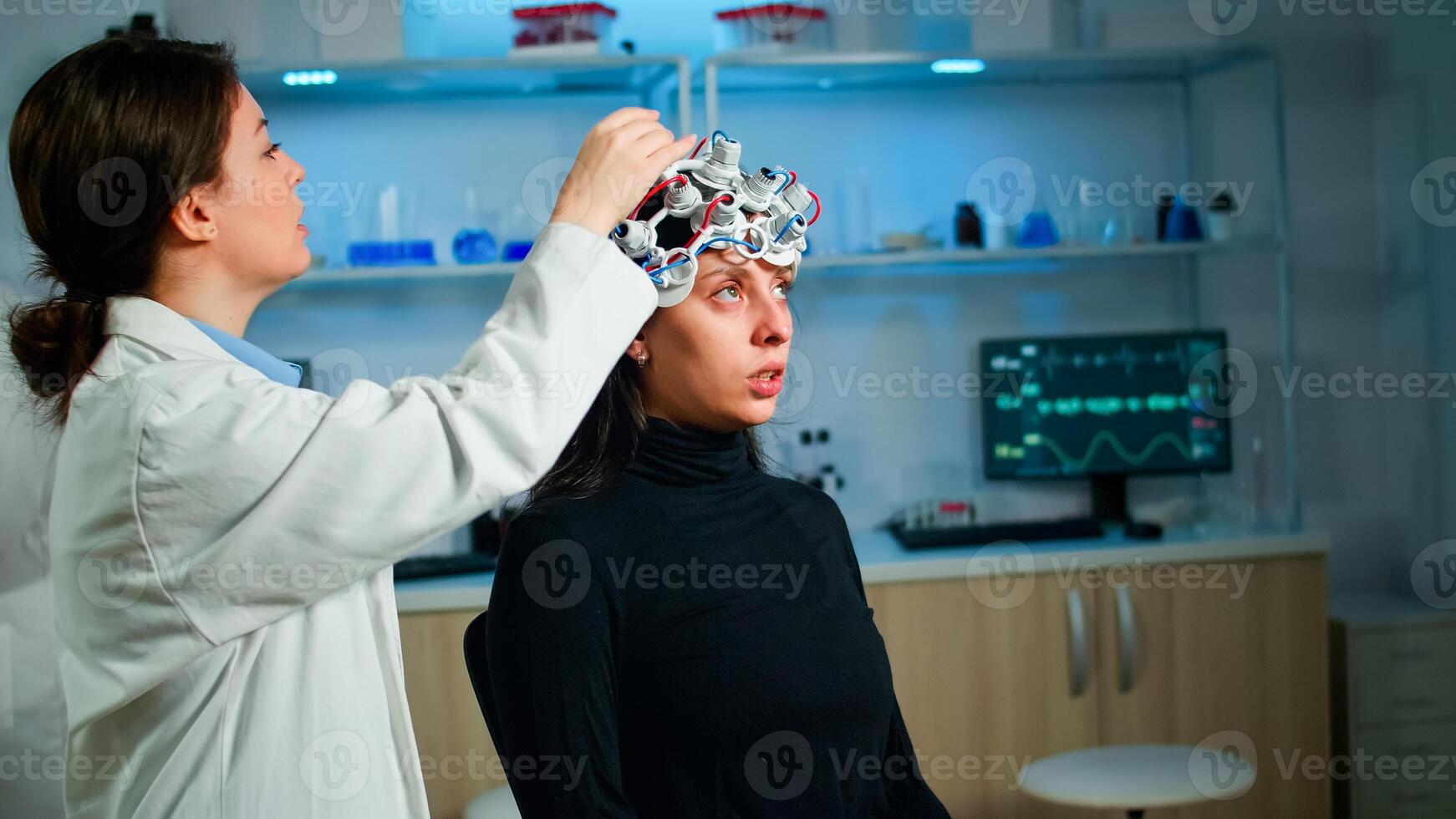 Woman patient visiting professional medical researcher in neurology medicine testing brain functions with eeg headset. Doctor monitoring nervous system, descovering diagnosis of disease. photo