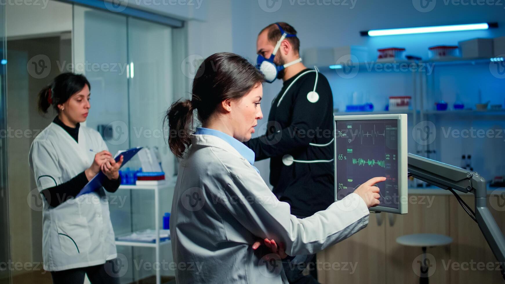 Professional male runner testing his muscle endurance in science sport lab facility, running with electrodes attached to his body monitoring health conditions, heart rate, psychological resistance photo