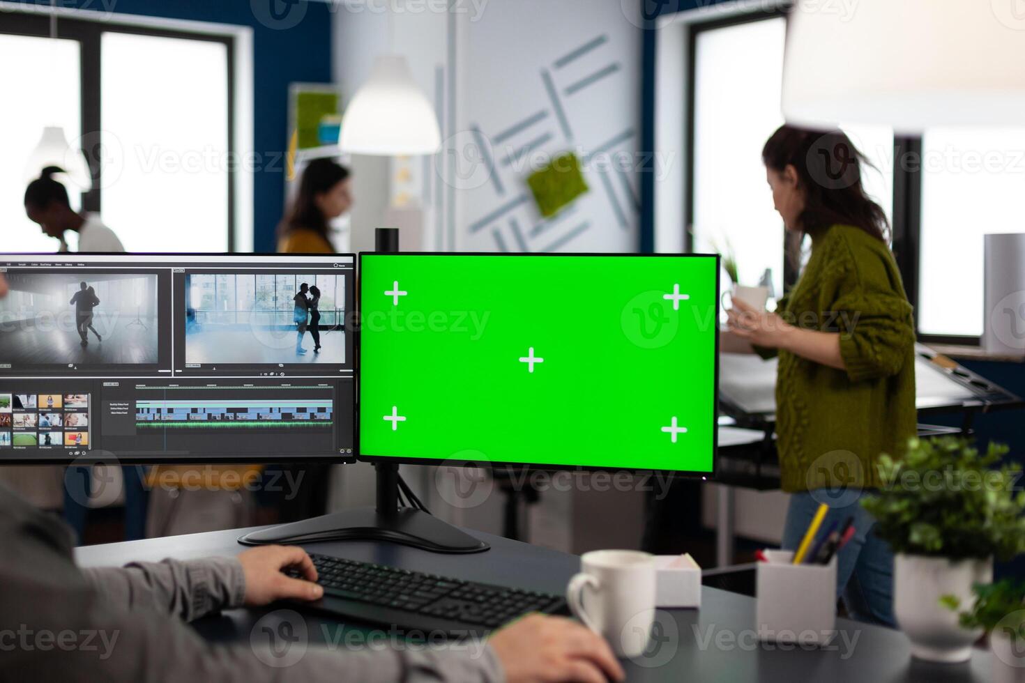editor using computer with chroma key, mock up isolated display editing project and audio footage. Videographer editor processing film montage on pc with green screen photo