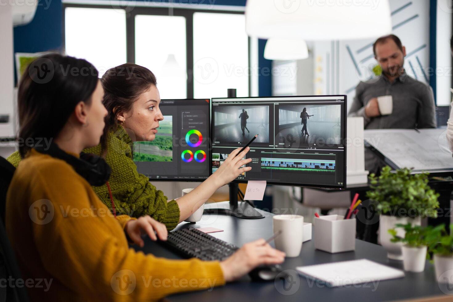 Team of editors women working with modern studio post production software in digital multimedia company. maker employees editing film montage in creative agency looking at computer photo