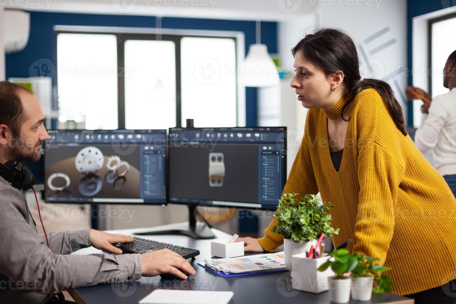 Teamwork engineer architects working on modern cad program developing construction metalic mechanism. Industrial designer studying prototype idea on pc showing digital software with gears concept photo