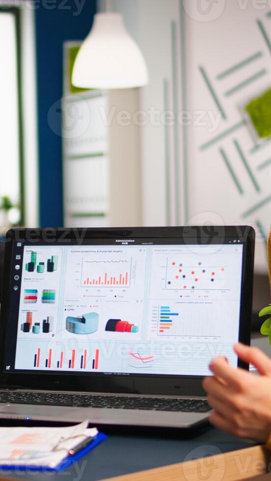 Business people talking with team leader using clipboard with documents pointing on it, presenting startup financial ideas to manager, brainstorming project management strategy in company office photo