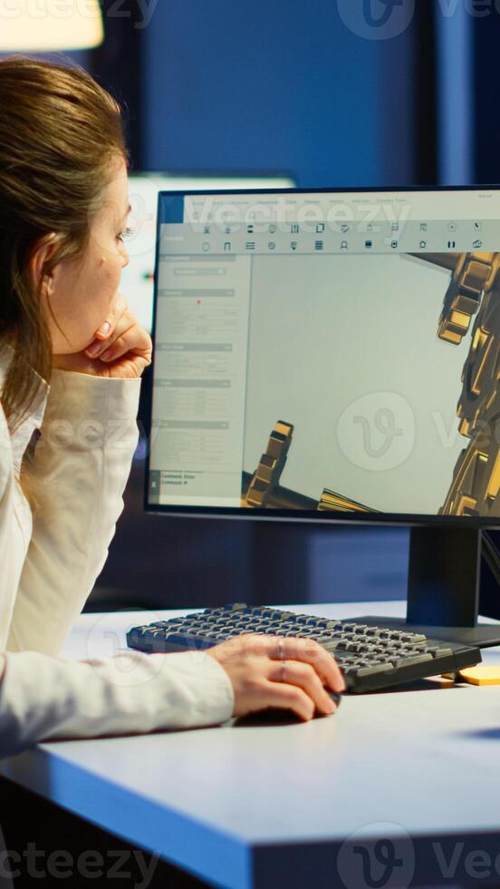 Tired woman architect working on modern cad program overtime sitting at desk in start-up office. Industrial female engineer studying prototype idea on pc showing cad software on device display photo