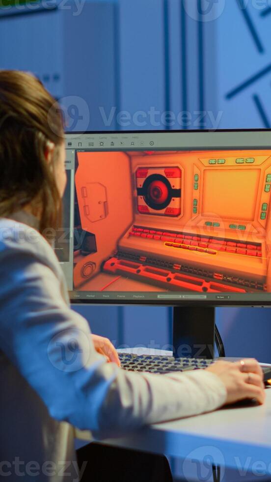 Woman game sotware developer testing new game overtime at night in start up creative agency company. Tired worker developing new online games on pc with modern technology photo
