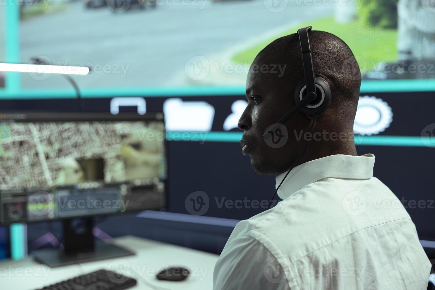 African american guy supervising traffic activity via CCTV system, using surveillance footage and radar in the city. Control center employee tracking cars through security cameras. photo