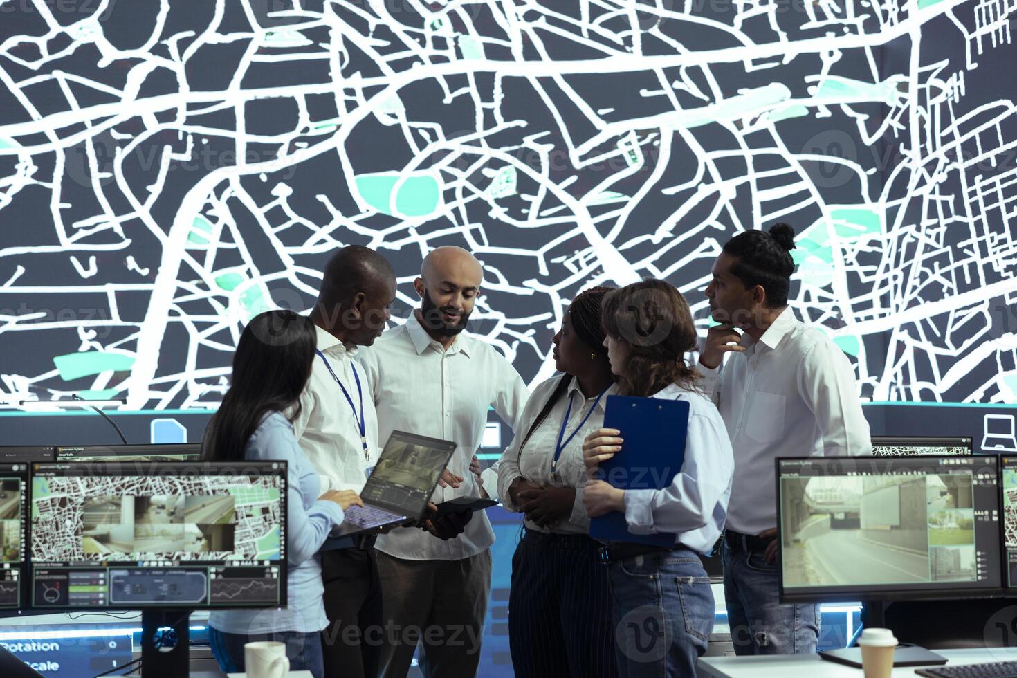 Diverse team of operators analyzing parcel awb and logistics to ensure order tracking service within the delivery app. Employee following truck drivers via gps coordinates on digital map. photo