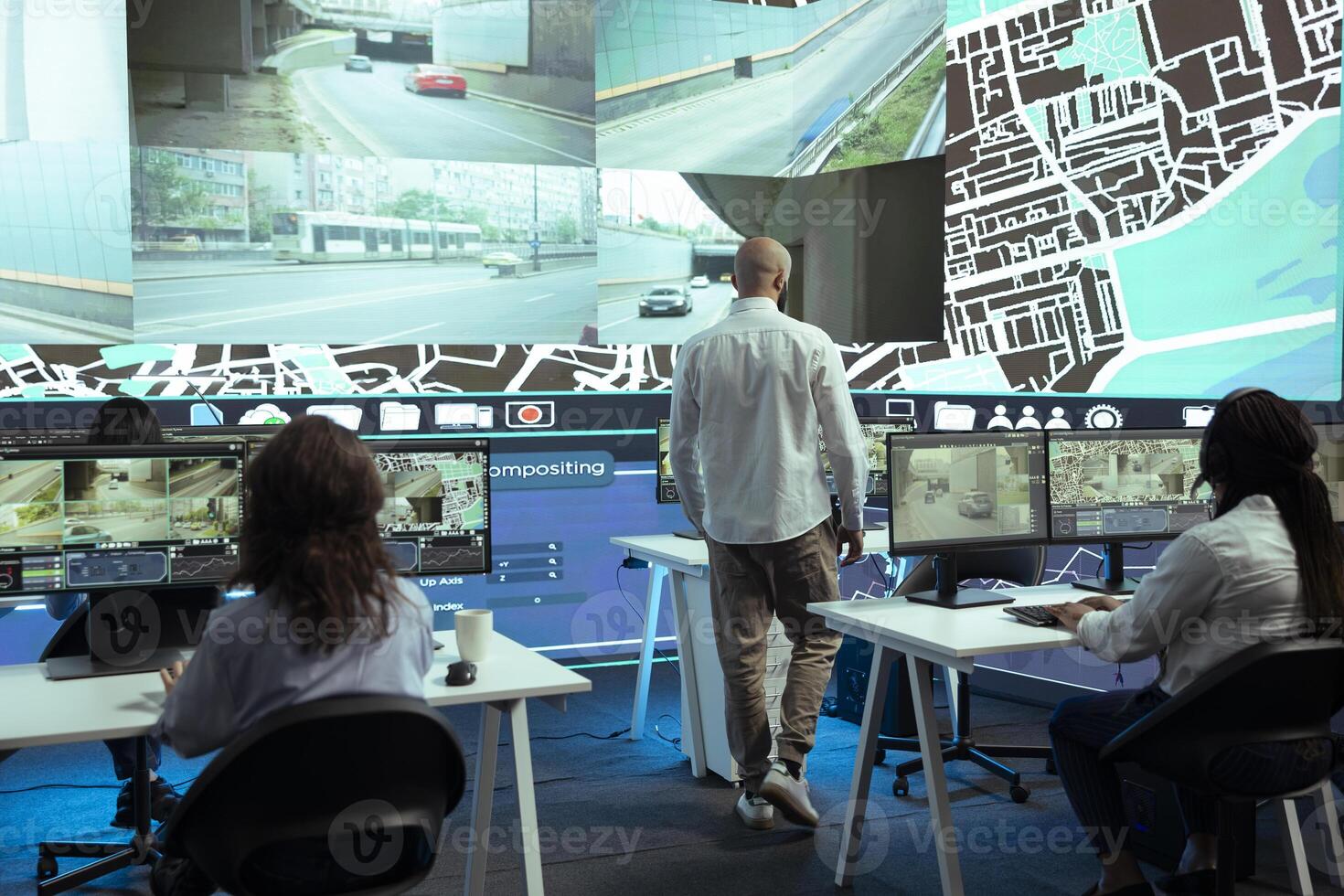 Middle eastern manager overseeing his staff order tracking activity, instructing operators to update customers on parcel shipment progress. Delivery agency monitoring their trucks in traffic. photo