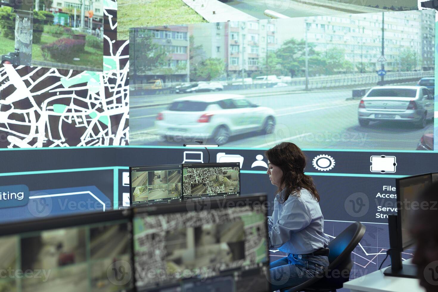 Diverse employees working on examining real time surveillance footage to find irregularities within urban traffic dynamics. Agency workers monitoring on CCTV system for intelligence. photo