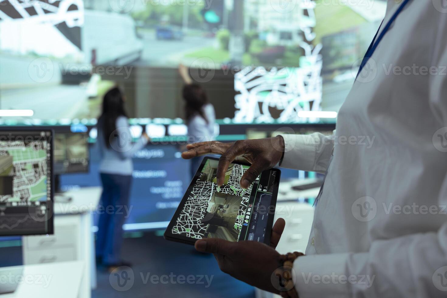 African american manager using a tablet to monitor delivery trucks around town, providing gps coordinates to ship at the exact location. Male supervisor oversees activity on satellite map. Close up. photo