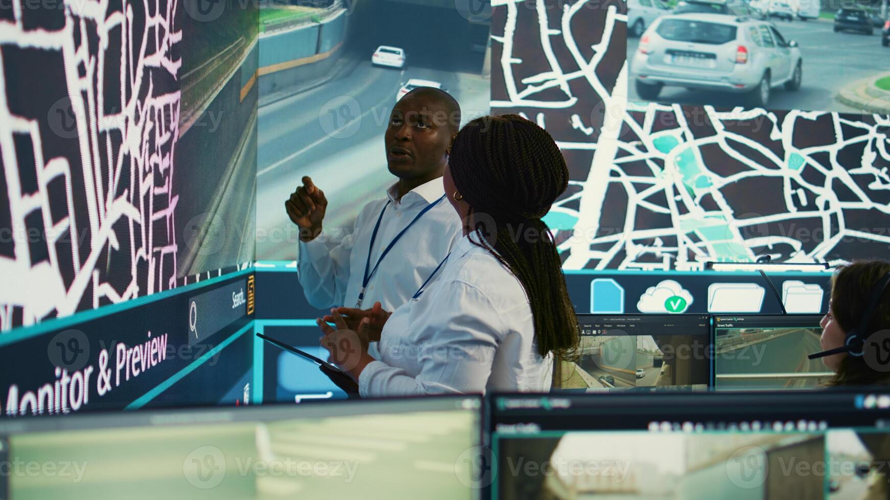 African american team monitoring routes and directions on satellite map, guiding delivery trucks to avoid traffic and ship orders faster. Operators consulting radar surveillance system. Camera B. photo