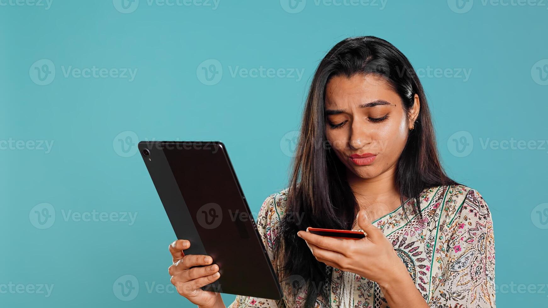 Woman trying to do purchases, frustrated with error received while adding payment method on website, studio background. Upset person unable to do internet shopping, getting card rejected, camera B photo