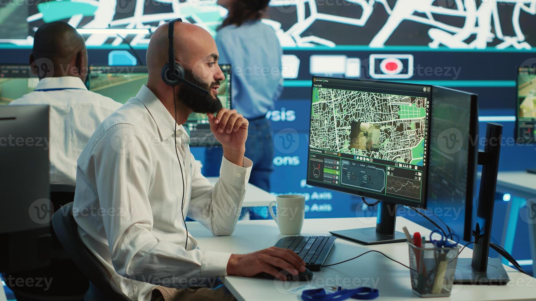 Middle eastern call center operator gives directions to the courier, avoid traffic by monitoring radar CCTV surveillance and a satellite city map. Employee helps with express delivery. Camera A. photo