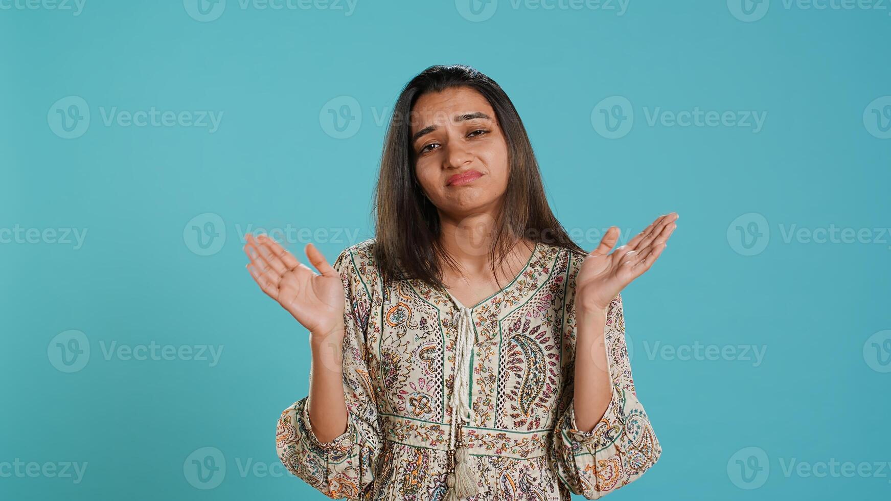 Lazy woman lacking interest for anything, feeling depressed, looking lifeless, isolated over studio background. Portrait of bored indian person suffering from tiredness, feeling exhausted, camera A photo