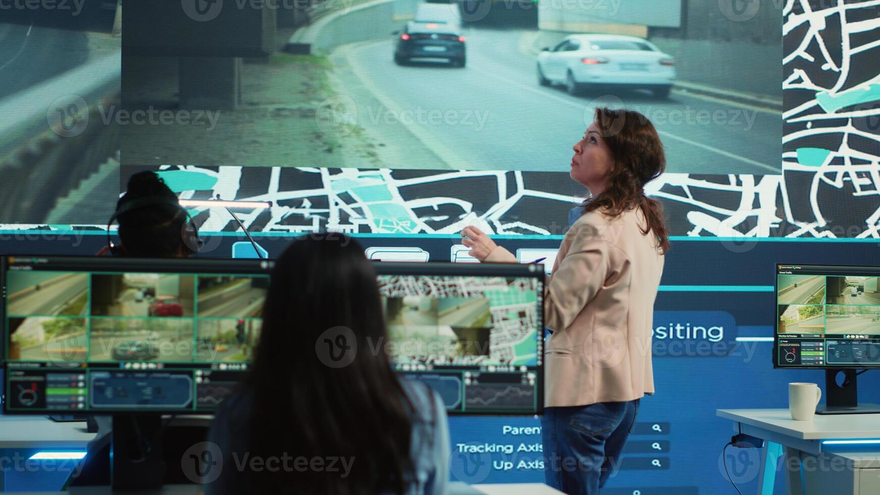 Manager supervising diverse employees operators in delivery call center office, people using global positioning system to guide shipment cars on city routes via satellite navigation map. Camera A. photo