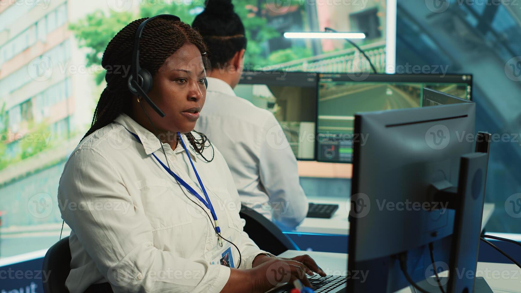 African american operator gathers gps coordinates and data for the government database, monitoring cars in traffic via surveillance CCTV security systems. Real time radar recordings. Camera A. photo