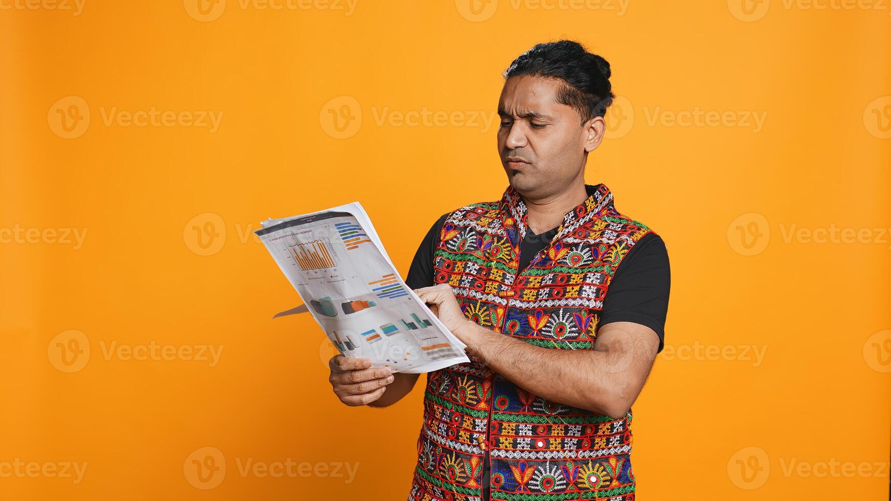 Irked manager browsing though financial audit report files, disappointed by work done by employees, studio background. Upset team leader throwing wrongly done paperwork in frustration, camera B photo