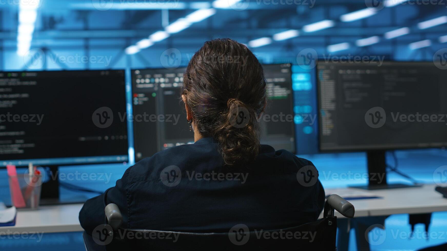 Person with disability in inclusive server hub workspace ensuring data remains shielded from threats. Close up shot of wheelchair user safeguarding data center establishment infrastructure photo