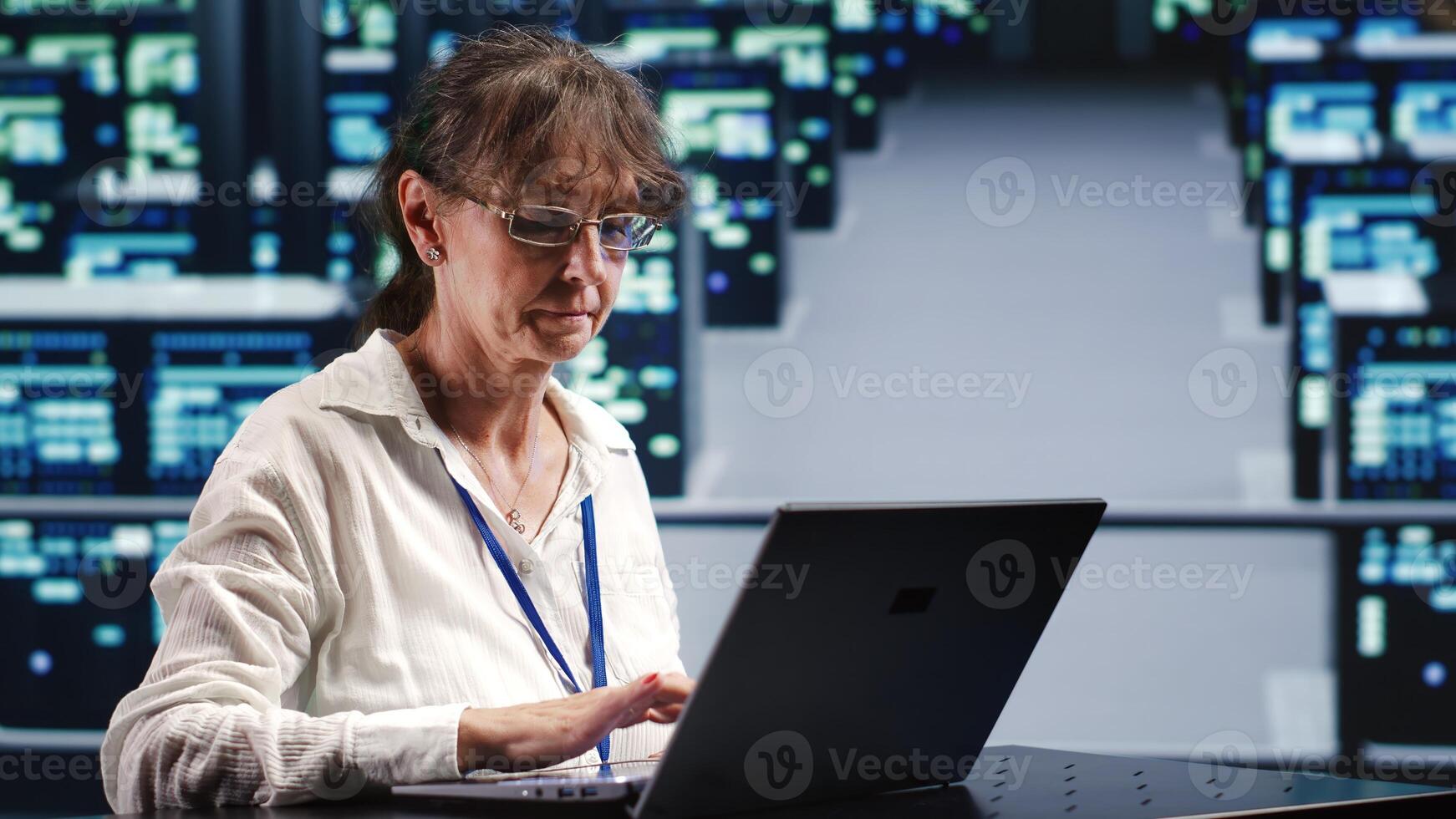 Dilligent inspector in data storage company equipped to handle complex computational operations, doing regular checking on server mainframes, verifying efficiency parameters to prevent damages photo