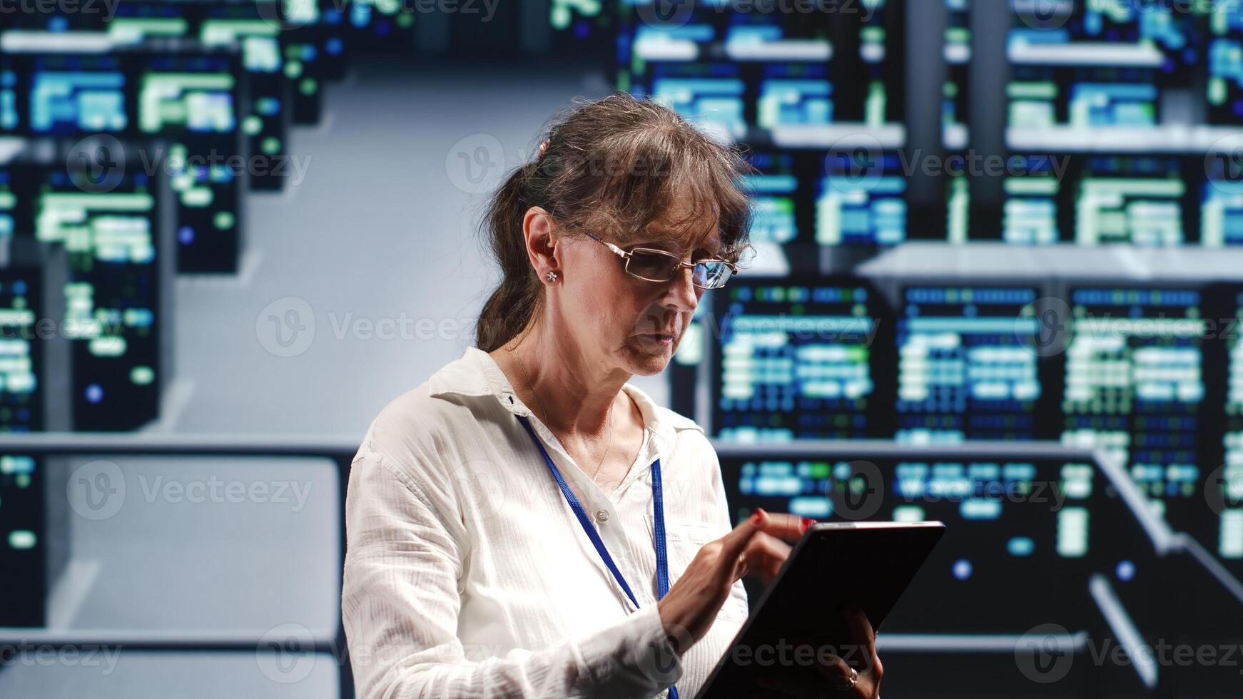Experienced manager in high tech workplace equipped to handle modern computing requirements, doing regular upgrades to server rows, increasing processing power and storage capacity to prevent bugs photo
