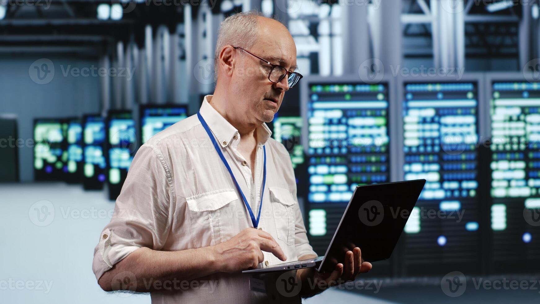 Focused IT support executive in data storage company equipped to handle complex computational operations, doing checking on server devices, verifying efficiency parameters to prevent liabilities photo